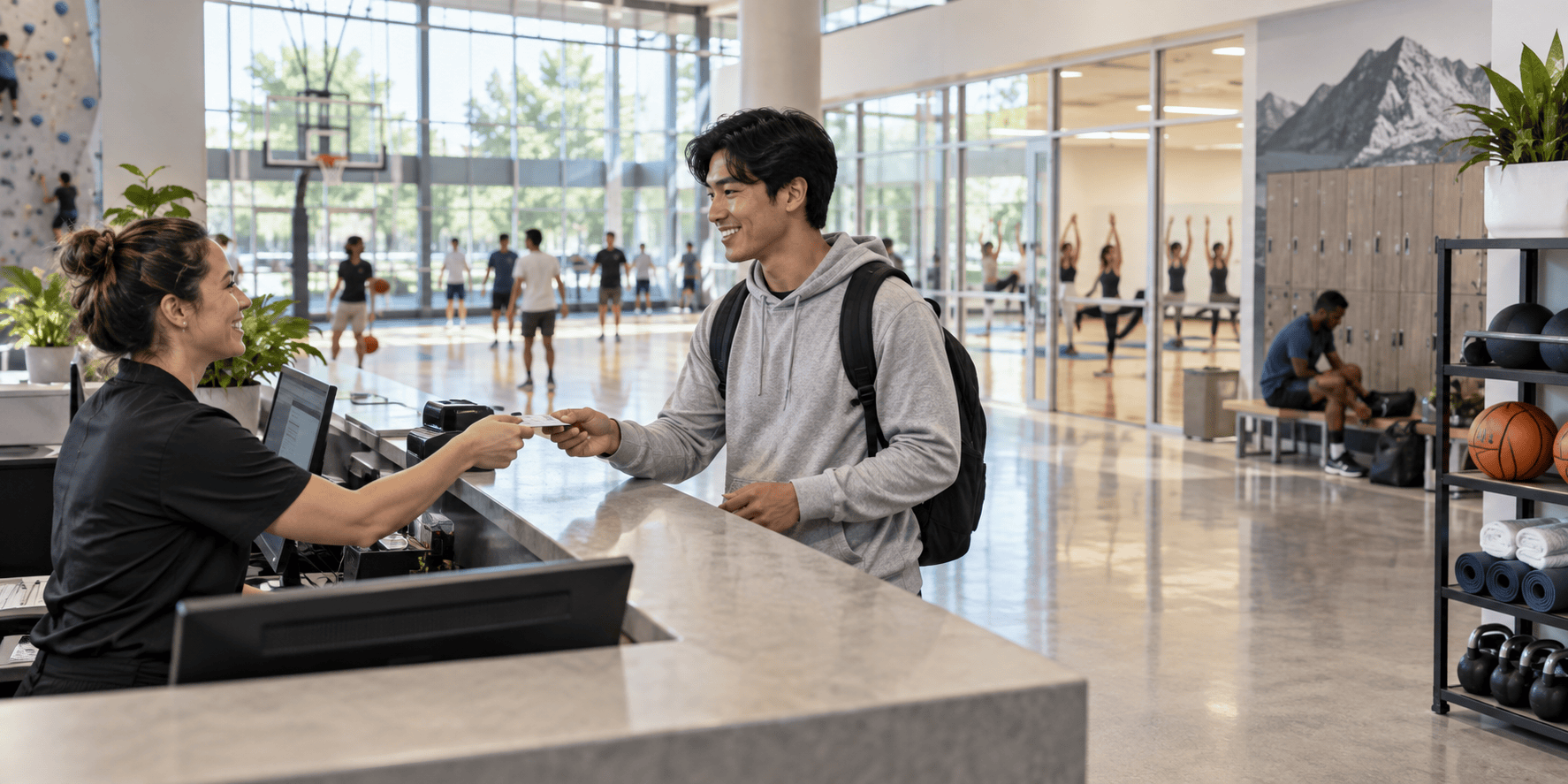 A student checking in at a modern university recreation center.